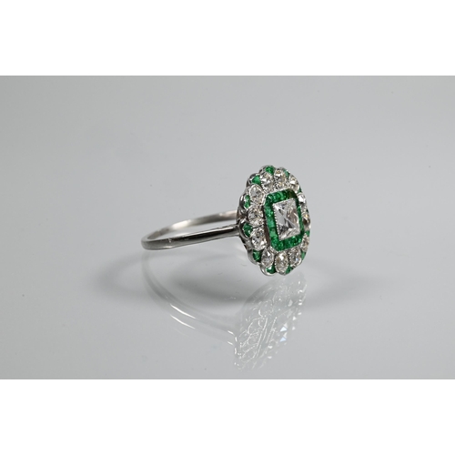 328 - An Art Deco cluster ring, the central assher cut diamond surrounded by a band of square cut emeralds... 