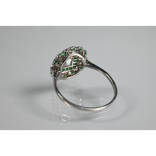 328 - An Art Deco cluster ring, the central assher cut diamond surrounded by a band of square cut emeralds... 