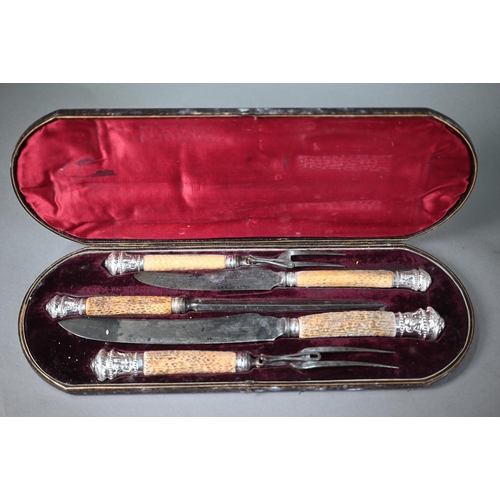 34 - Victorian cased five-piece carving set, the antler handles with ep pommels embossed with rams' heads... 