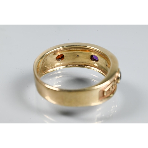 340A - A 9ct yellow gold gentleman's ring in the Victorian Gothic revival style set with oval garnet, sapph... 