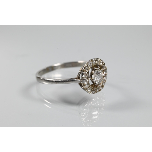 348 - An antique diamond floating halo cluster ring formed of a central old cut diamond with diamond surro... 