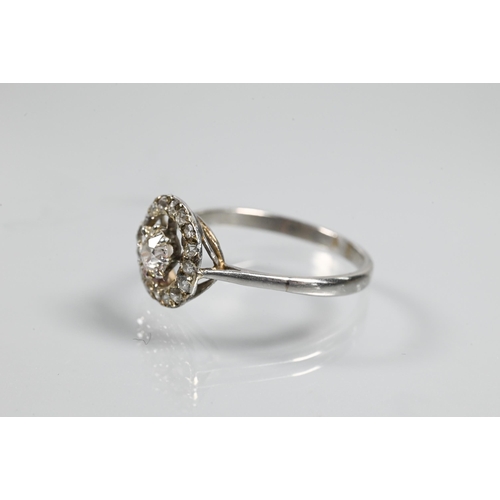 348 - An antique diamond floating halo cluster ring formed of a central old cut diamond with diamond surro... 