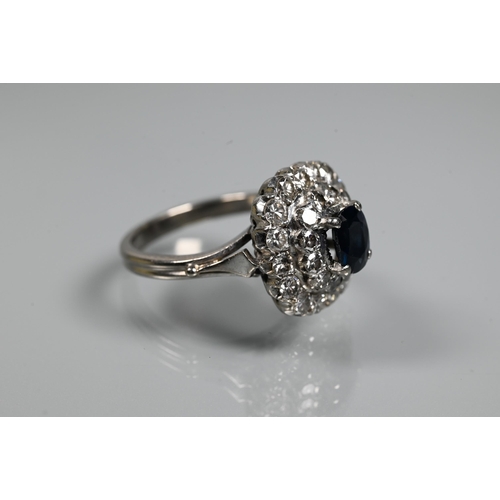 363 - A sapphire and diamond cluster ring, the rectangular diamond cluster formed of two rows supporting a... 