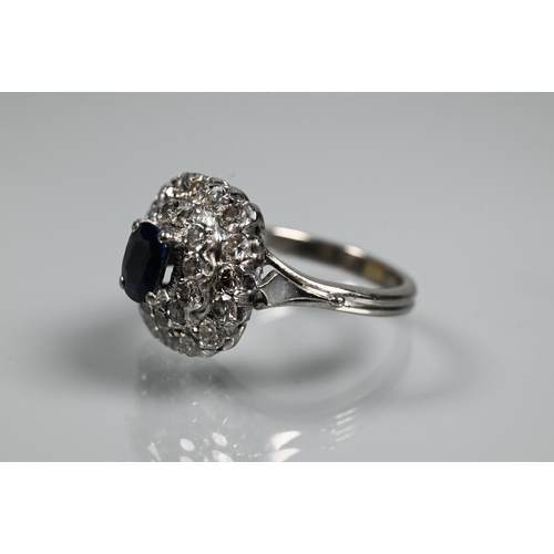 363 - A sapphire and diamond cluster ring, the rectangular diamond cluster formed of two rows supporting a... 