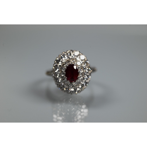 364 - A diamond ruby cluster ring, the oval two row diamond cluster supporting an oval ruby in high claw s... 