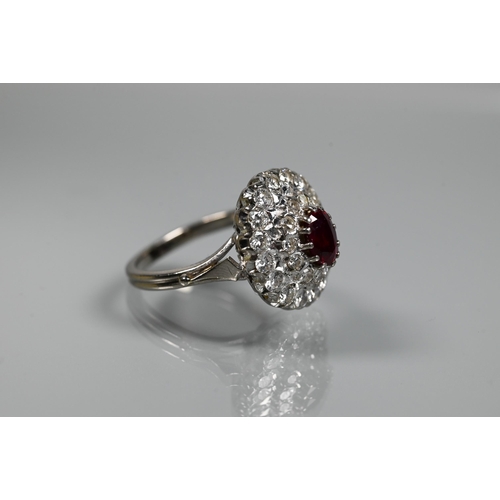 364 - A diamond ruby cluster ring, the oval two row diamond cluster supporting an oval ruby in high claw s... 