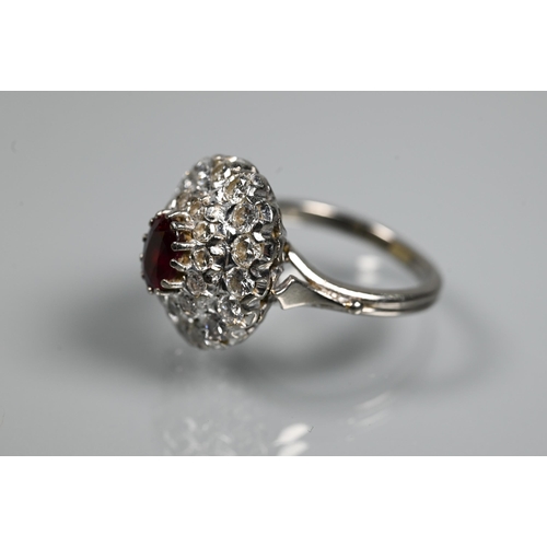 364 - A diamond ruby cluster ring, the oval two row diamond cluster supporting an oval ruby in high claw s... 