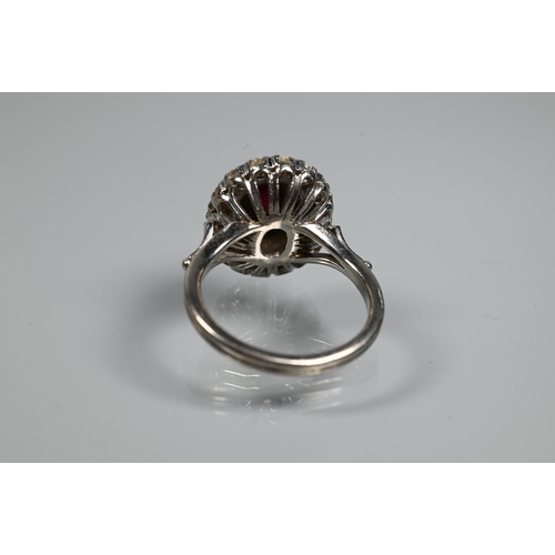 364 - A diamond ruby cluster ring, the oval two row diamond cluster supporting an oval ruby in high claw s... 