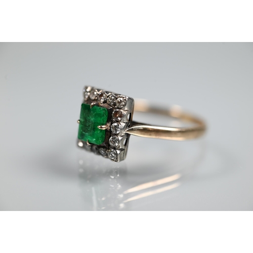 365 - An emerald and diamond cluster ring, the central rectangular cut emerald with diamond surround, unma... 