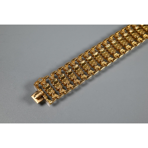 382 - A yellow gold wide bracelet formed of fancy baton links, concealed clasp, stamped 750, approx 29g