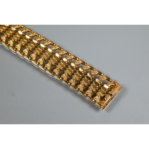 382 - A yellow gold wide bracelet formed of fancy baton links, concealed clasp, stamped 750, approx 29g