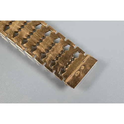 382 - A yellow gold wide bracelet formed of fancy baton links, concealed clasp, stamped 750, approx 29g