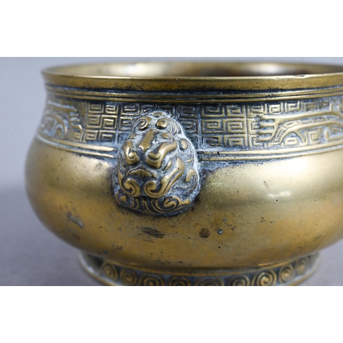 401 - A 19th century Chinese bronze censer or incense burner of compressed globular form with cast taotie ... 