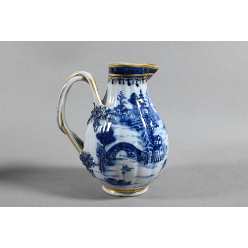 407 - An 18th century Chinese export blue and white sparrow-beak jug and cover with moulded pomegranate fi... 