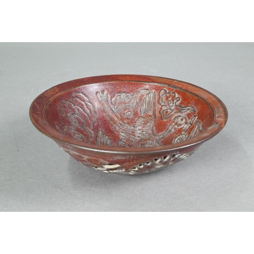 413 - A Chinese chocolate brown glazed bowl, the interior decorated in low relief with two phoenix and sty... 