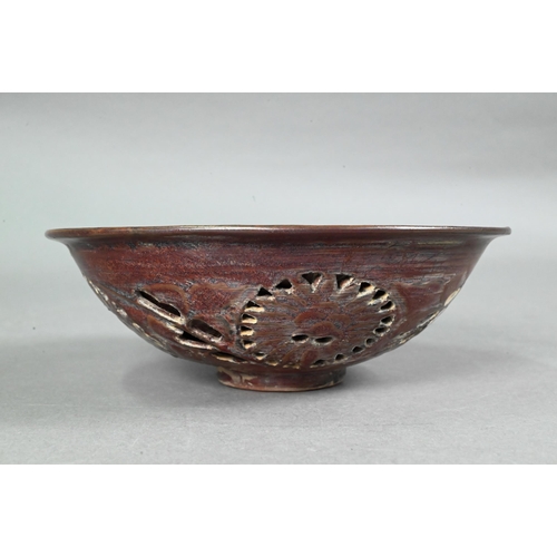 413 - A Chinese chocolate brown glazed bowl, the interior decorated in low relief with two phoenix and sty... 