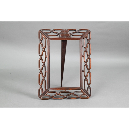 423 - A 20th century Chinese pierced hardwood frame with carved 'shou' symbol and strut stand, 30 cm high ... 