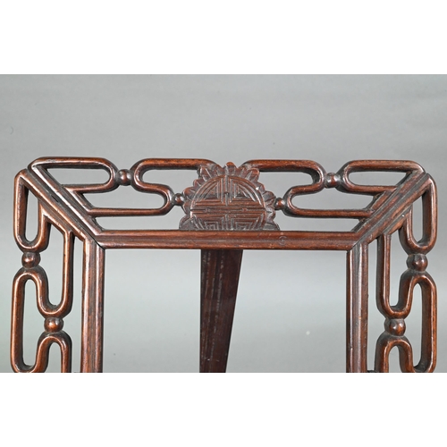 423 - A 20th century Chinese pierced hardwood frame with carved 'shou' symbol and strut stand, 30 cm high ... 