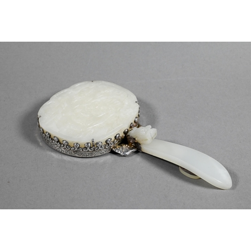 430 - A 19th century Chinese white jade and white metal mounted hand mirror, Qing dynasty, with cloud shap... 