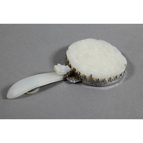 430 - A 19th century Chinese white jade and white metal mounted hand mirror, Qing dynasty, with cloud shap... 