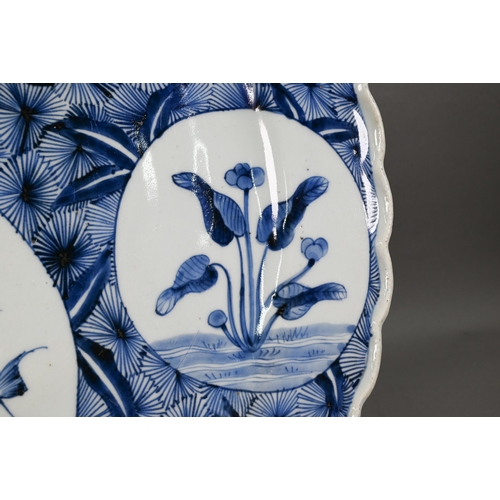 436 - A 19th century Japanese blue and white floriform charger, painted with a goose and bamboo within a f... 