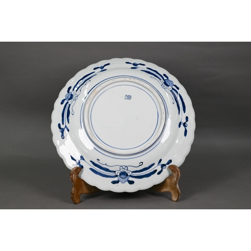 436 - A 19th century Japanese blue and white floriform charger, painted with a goose and bamboo within a f... 