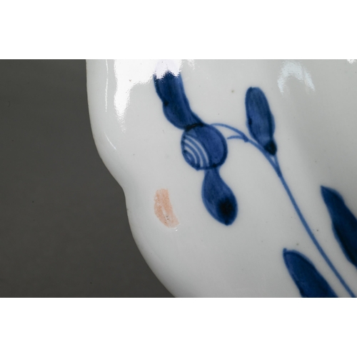 436 - A 19th century Japanese blue and white floriform charger, painted with a goose and bamboo within a f... 