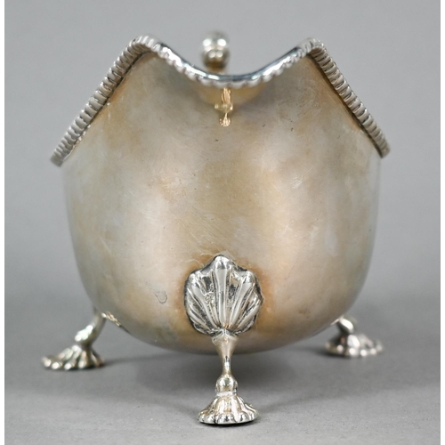 44 - Silver sauce boat in the Georgian manner, with beaded rim and scroll handle, on three shell feet, Wa... 