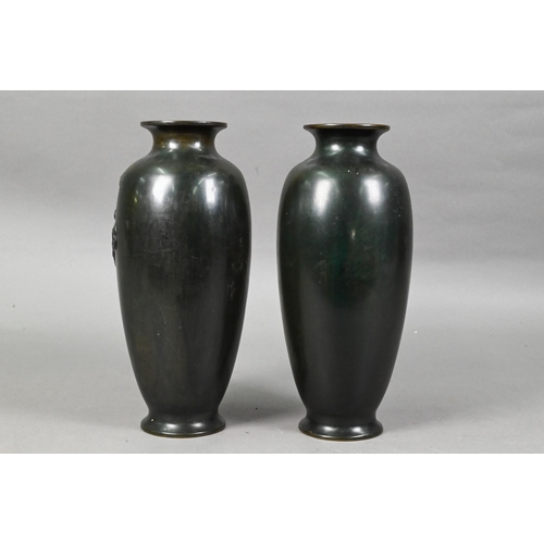 448 - A pair of Japanese base metal vases cast in high relief with fierce three-clawed dragons, simulated ... 