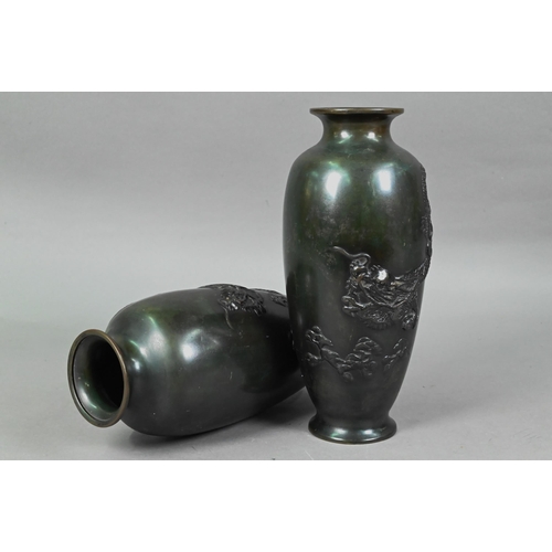 448 - A pair of Japanese base metal vases cast in high relief with fierce three-clawed dragons, simulated ... 