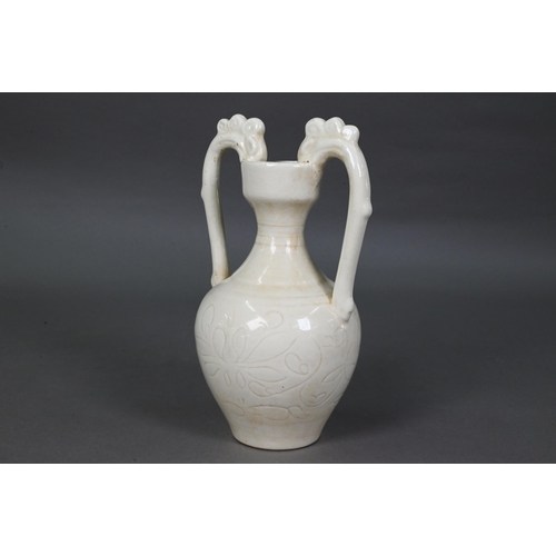 452 - A Chinese Tang style white glazed 'amphora' vase, the looping handles with dragon head terminals bit... 