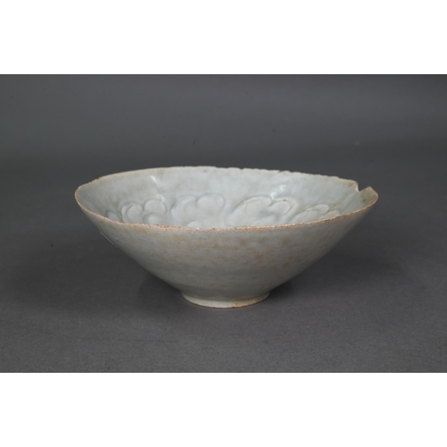 453 - A Chinese Qingbai bowl, Song Dynasty (960-1279) with incised cloud motif design under the pale celad... 