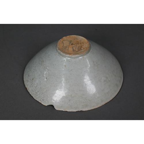 453 - A Chinese Qingbai bowl, Song Dynasty (960-1279) with incised cloud motif design under the pale celad... 