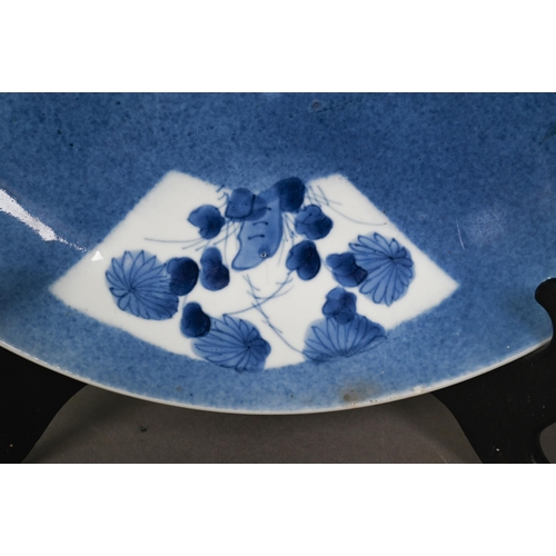 463 - A 18th/19th century Chinese blue and white shallow bowl, painted in underglaze blue with flowers wit... 