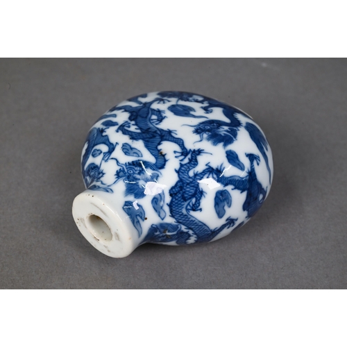 467 - A Chinese blue and white 'dragon' snuff bottle, the flattened oval body painted in underglaze blue w... 