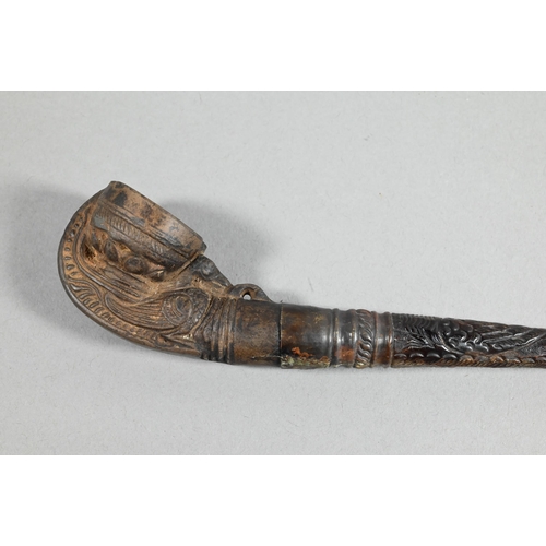 473 - An antique Tibetan Buddhist ritual pipe with moulded clay bowl inserted into the long embossed coppe... 