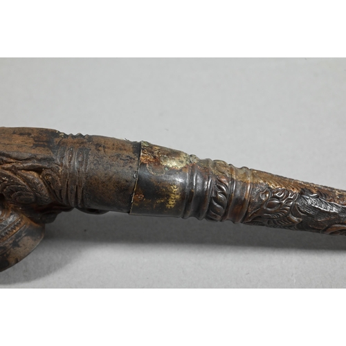 473 - An antique Tibetan Buddhist ritual pipe with moulded clay bowl inserted into the long embossed coppe... 