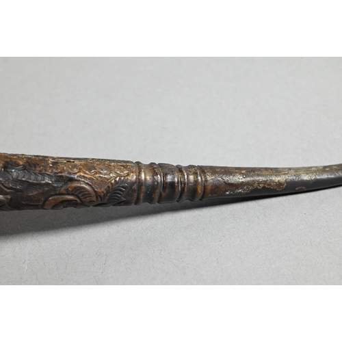 473 - An antique Tibetan Buddhist ritual pipe with moulded clay bowl inserted into the long embossed coppe... 