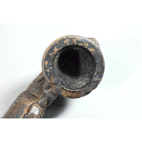 473 - An antique Tibetan Buddhist ritual pipe with moulded clay bowl inserted into the long embossed coppe... 