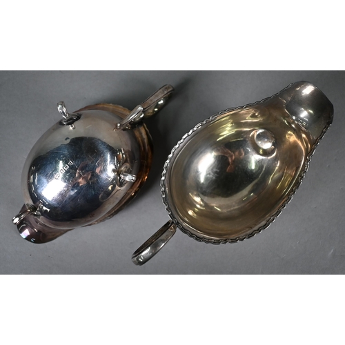 48 - Pair of silver sauce boats in the Georgian manner, with shaped and reeded rims and scroll handles an... 