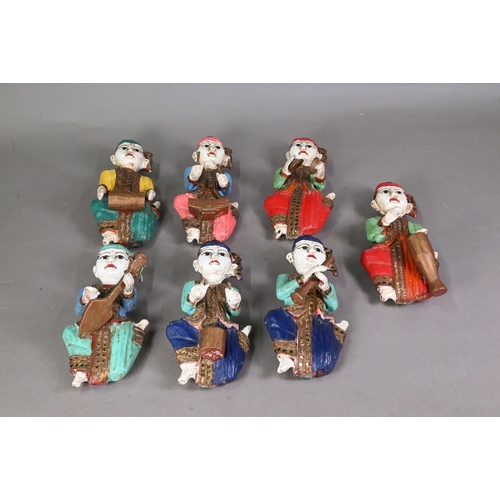 480 - A set of seven vintage polychrome Burmese temple musician wall plaques, carved hardwood with gilded ... 