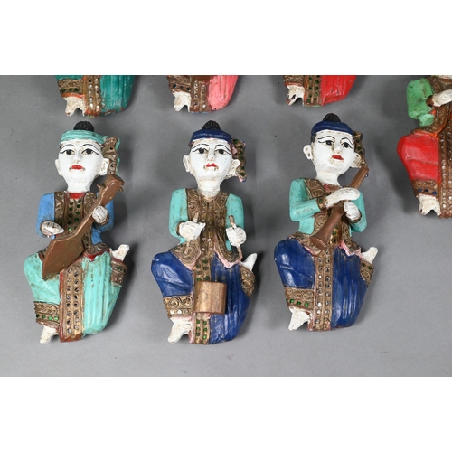 480 - A set of seven vintage polychrome Burmese temple musician wall plaques, carved hardwood with gilded ... 