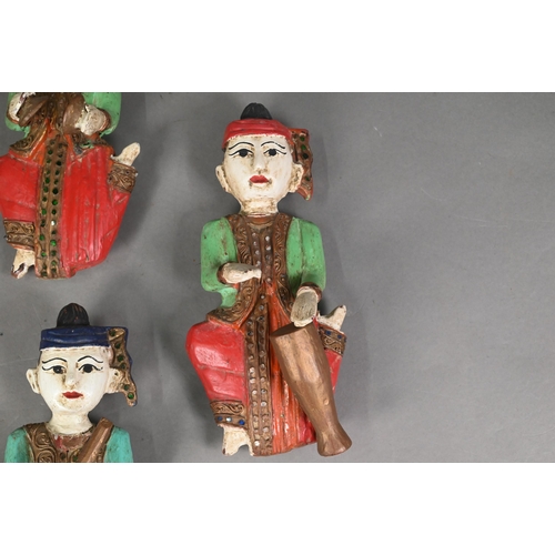 480 - A set of seven vintage polychrome Burmese temple musician wall plaques, carved hardwood with gilded ... 