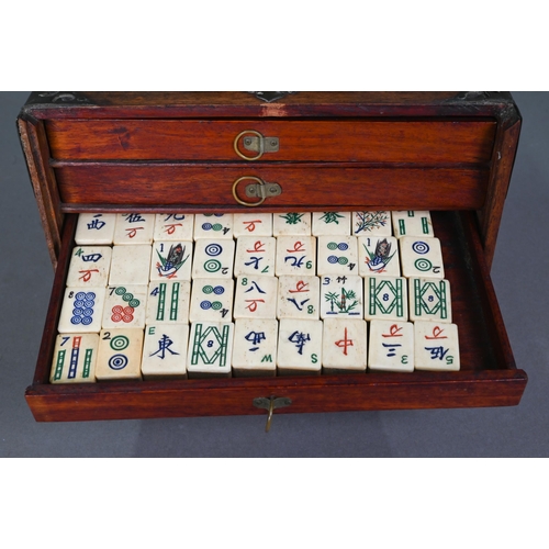 482 - A Chinese Mah Jong set, the hardwood brass mounted case having two brass handles and sliding front p... 