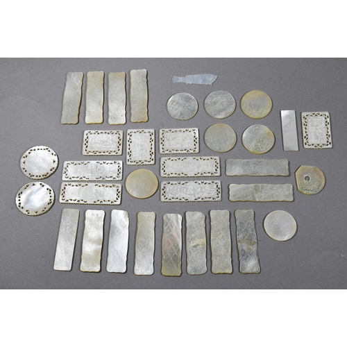 484 - A collection of 18th and 19th century Chinese mother-of-pearl gaming counters including a mounted ar... 