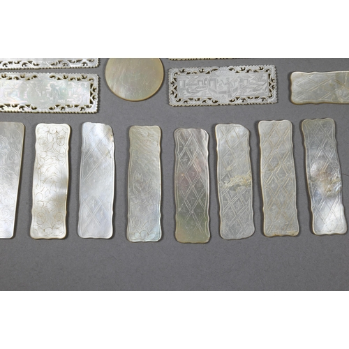 484 - A collection of 18th and 19th century Chinese mother-of-pearl gaming counters including a mounted ar... 