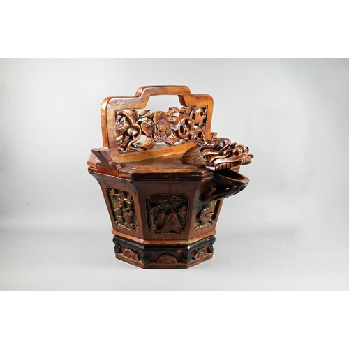 488 - A Chinese stained hardwood water bucket of tapering octagonal form with floral and foliate fret-cut ... 