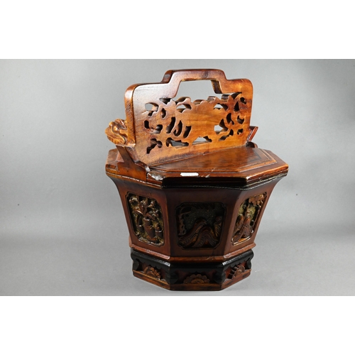 488 - A Chinese stained hardwood water bucket of tapering octagonal form with floral and foliate fret-cut ... 