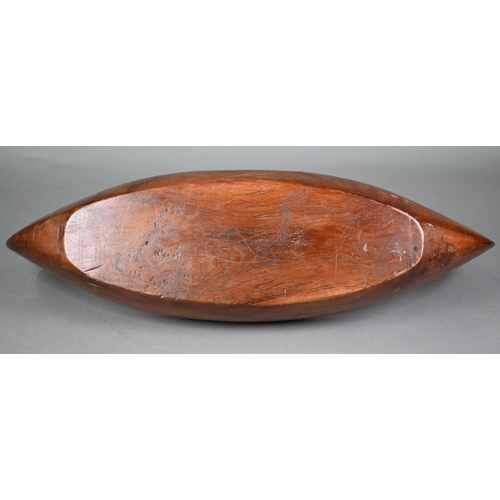 491 - An Indonesian stained and hollowed hardwood fruit bowl on stand in the form of a dugout canoe, 65 cm... 