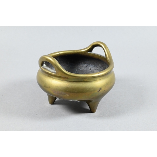 492 - A 19th century Chinese bronze incense burner or censer of typical tripod form with compressed globul... 